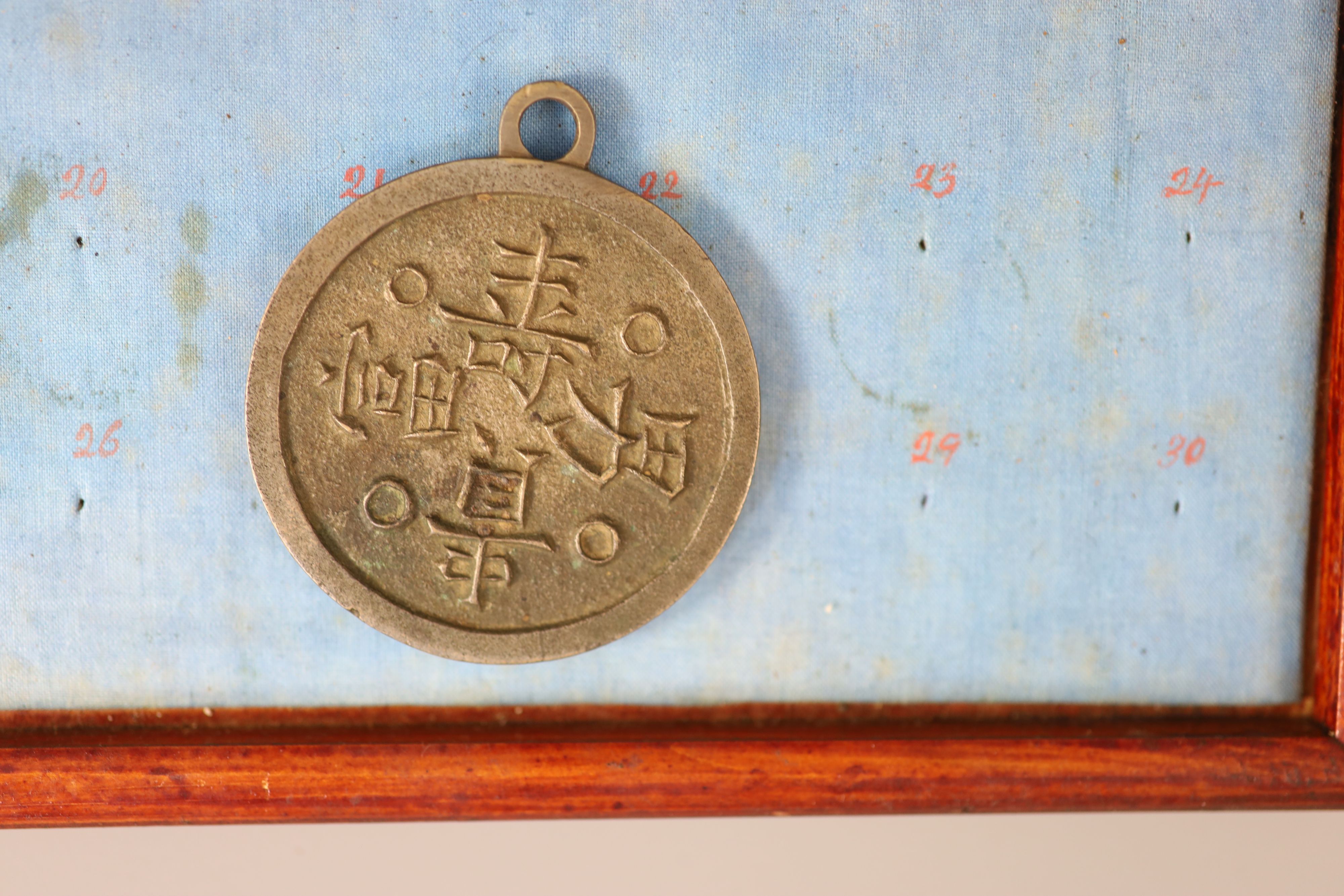 A group of 99 Korean bronze and metal amulets or charms, 19th/20th century